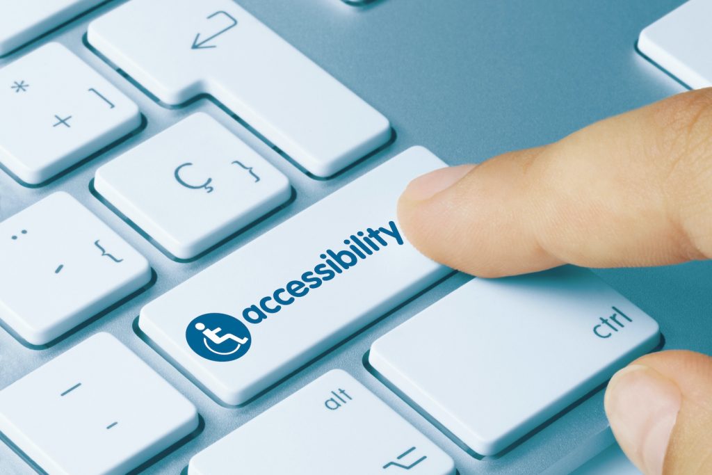 Close-Up of keyboard with finger hovering over a button that says "accessibility.